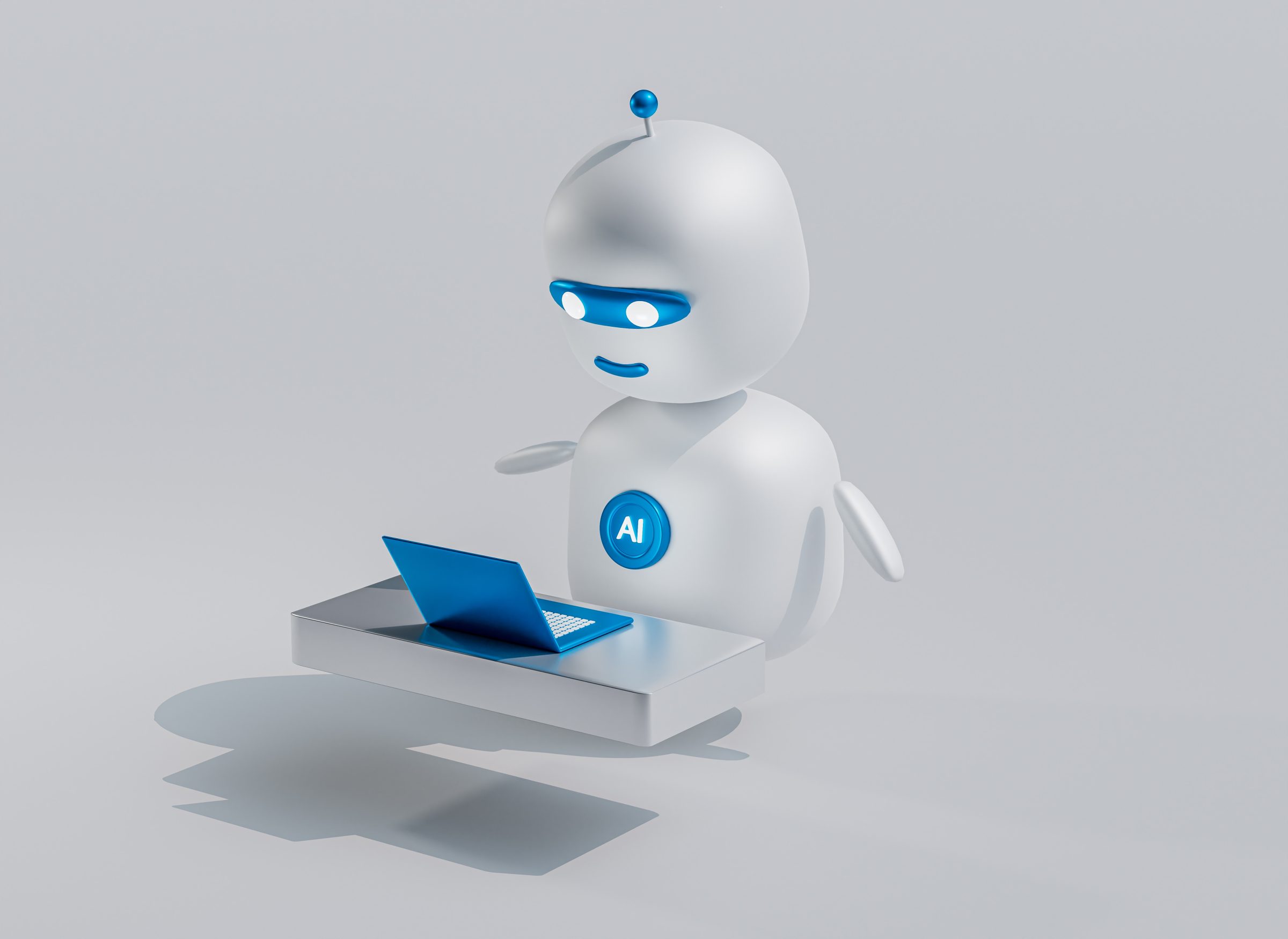 little white robot in front of computer